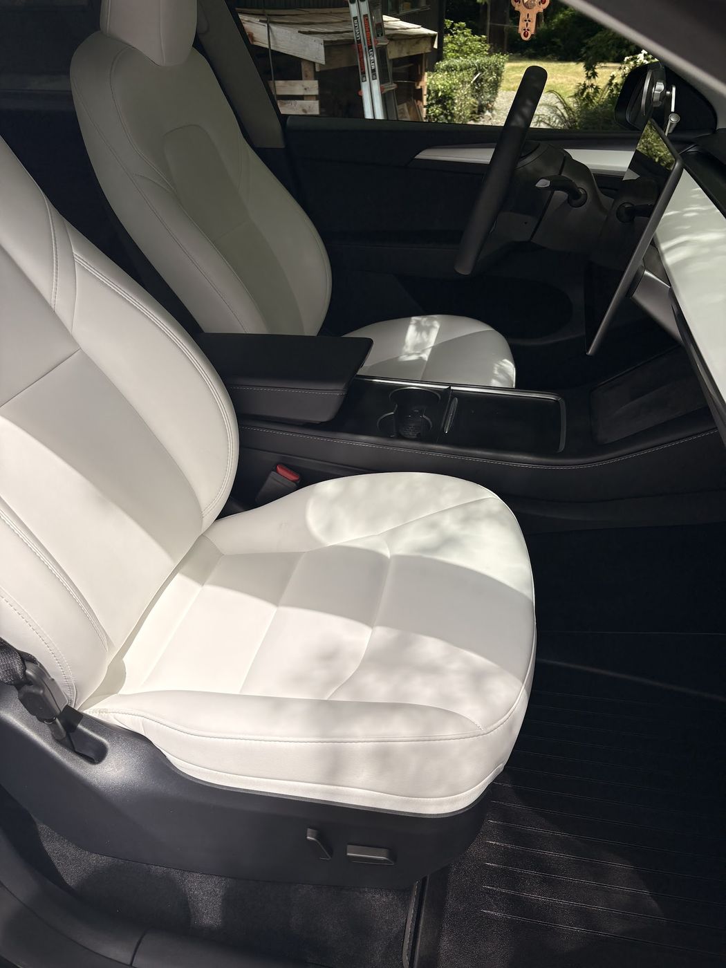 White Tesla front seats after an interior detail